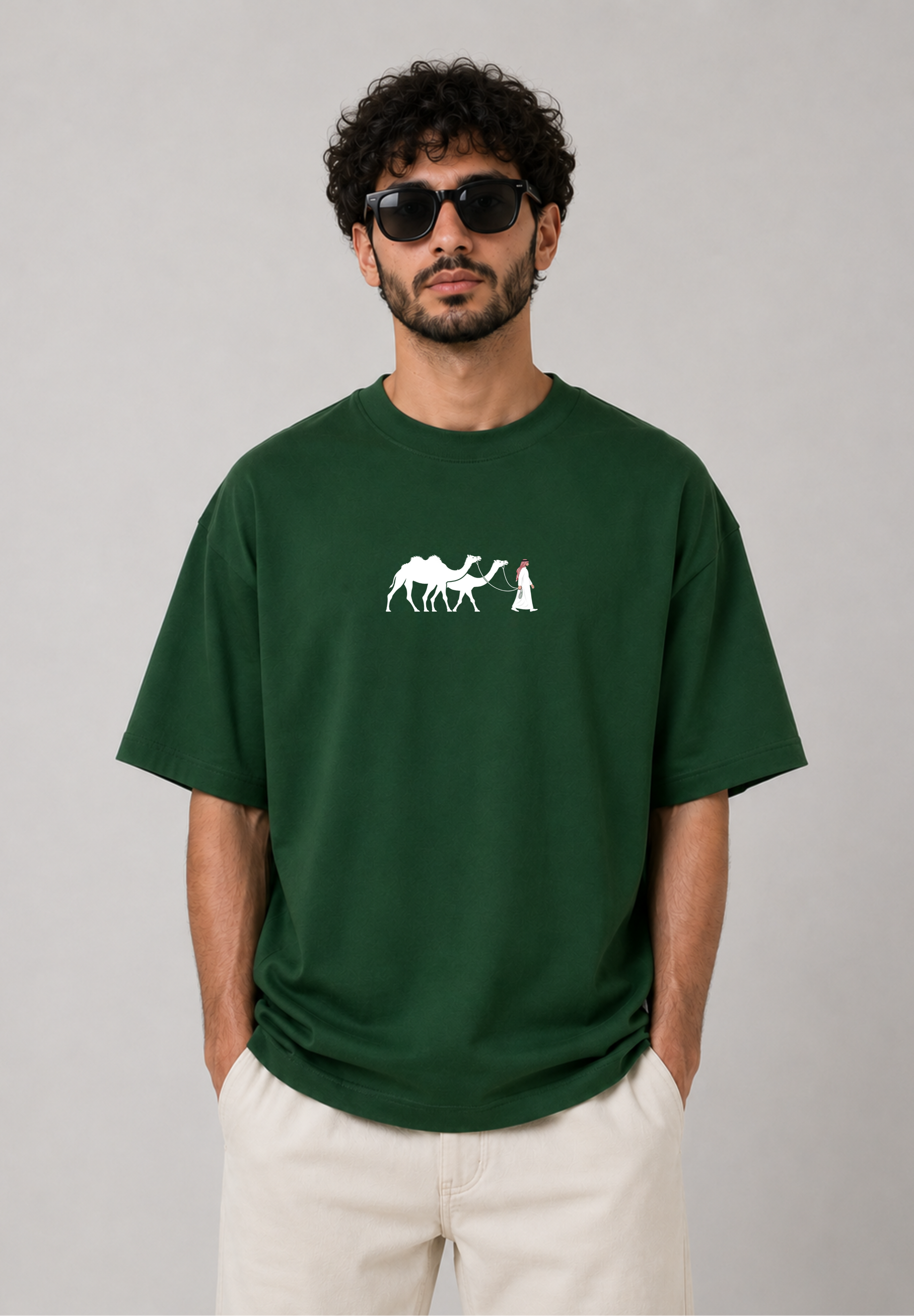 Man wearing a green t-shirt with a white graphic design on a gray background