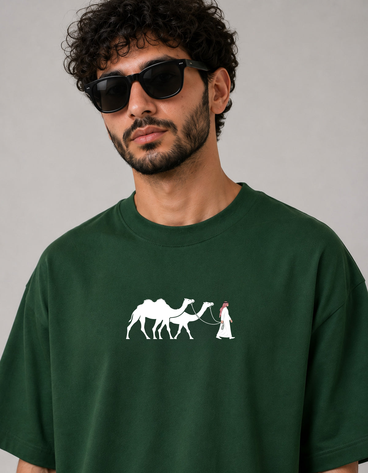 one5ive dark green oversized cotton t-shirt featuring a white graphic of a person walking camels